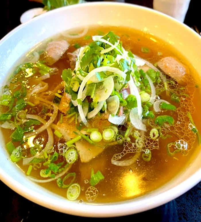 A bowl of Viet Taste beef pho with fresh herbs